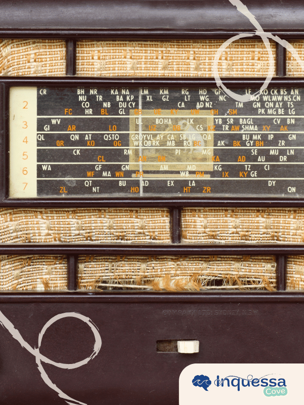 Close-up of a vintage radio with a woven speaker grille and station dial