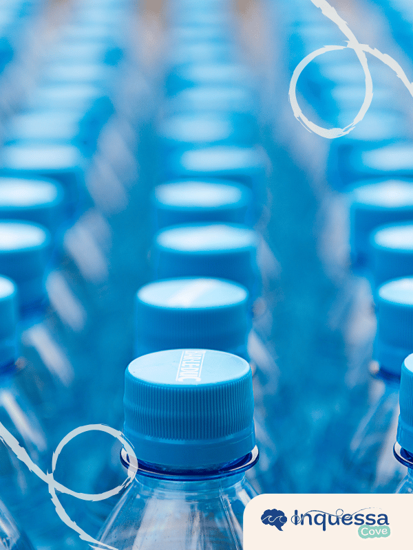 Rows of clear plastic water bottles with blue caps