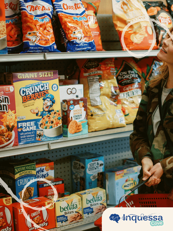 Shopper standing beside supermarket shelves filled with packaged snack foods