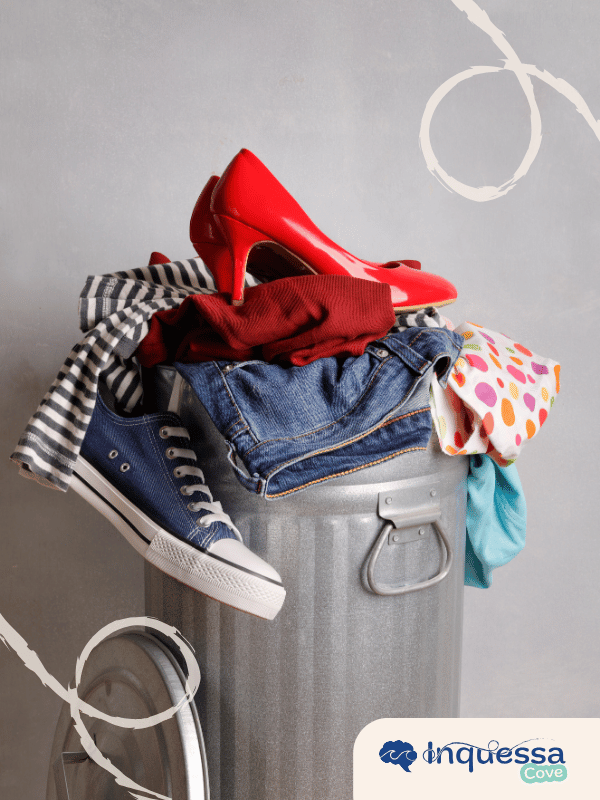 Clothing and shoes overflowing from a metal trash can