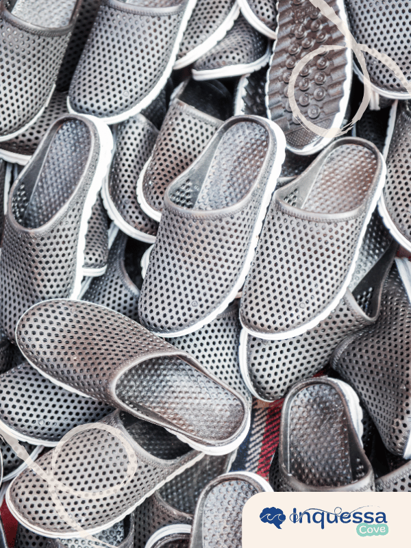 Large pile of gray synthetic shoes