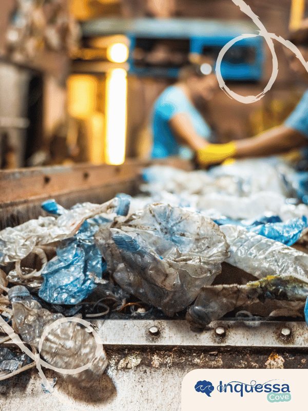 Crushed plastic bottles and film moving through a recycling facility
