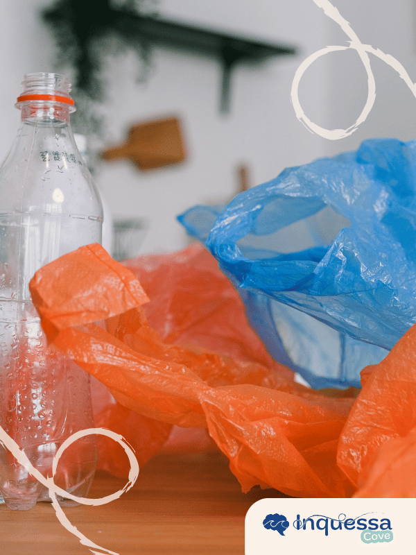 Clear plastic bottle and colorful plastic bags on a table