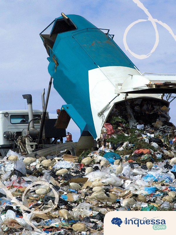 Garbage truck unloading mixed waste at a landfill
