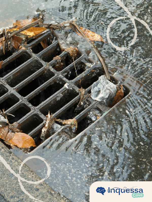 Storm drain carrying leaves and litter in flowing water