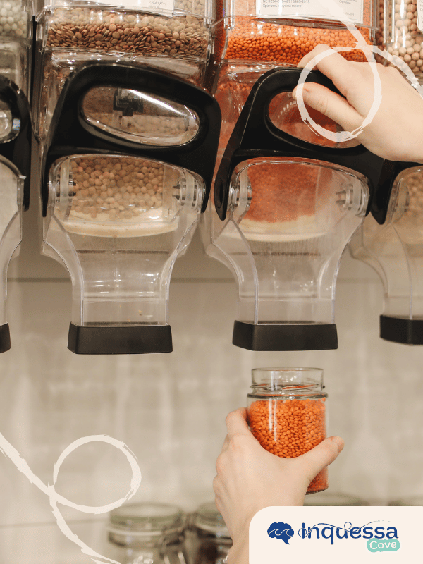 Person carrying stacked reusable glass food containers filled with pasta