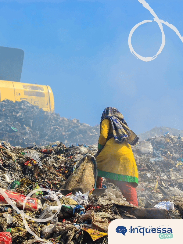 Person collecting materials from a large landfill surrounded by mixed waste