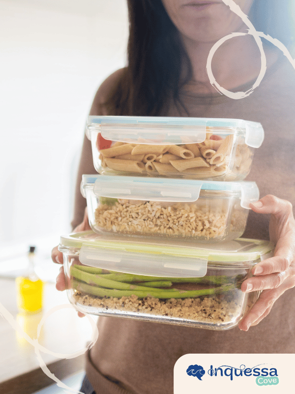 Person filling a reusable glass jar with lentils from a bulk food dispenser